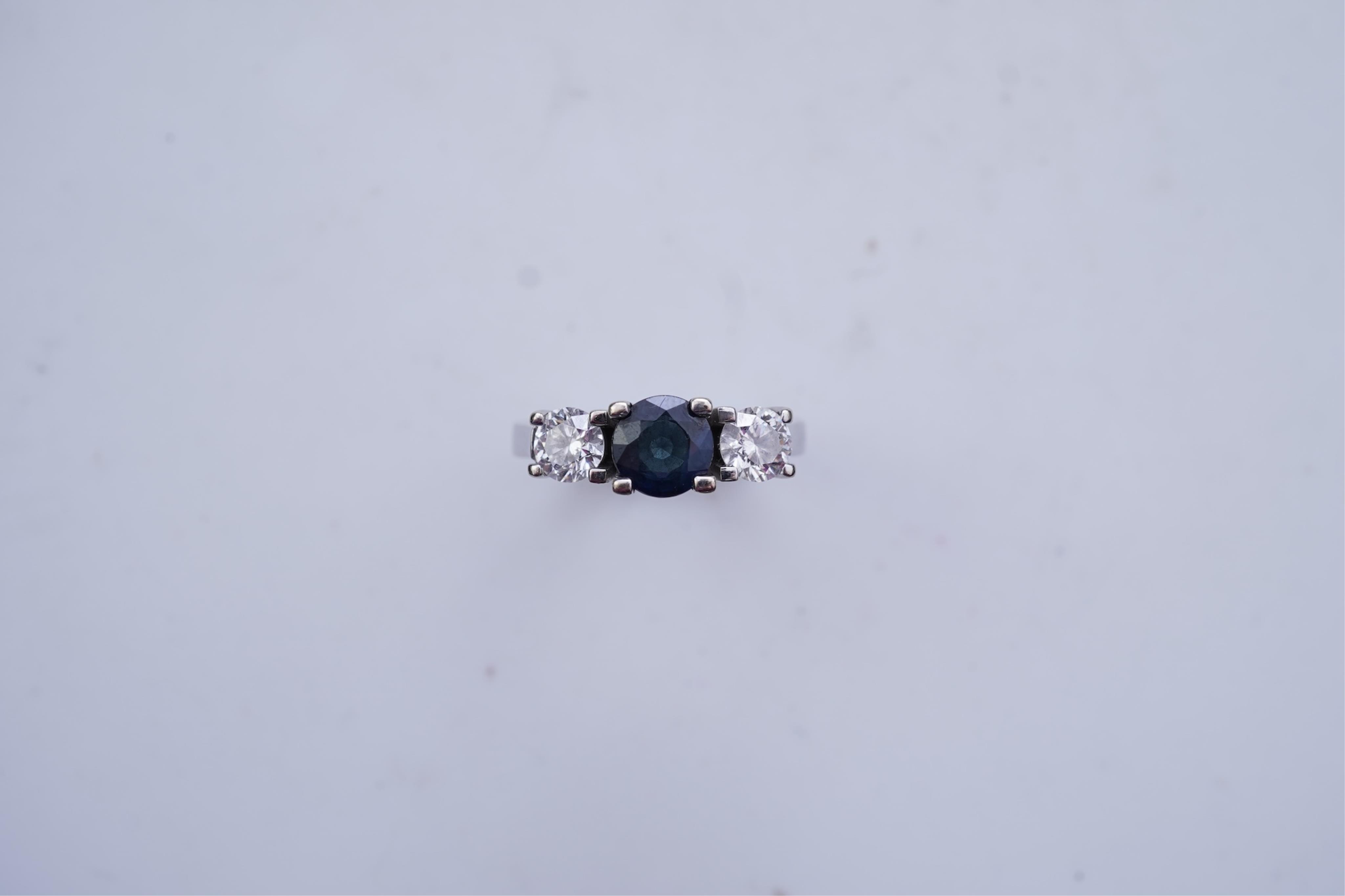 A sapphire and diamond three-stone ring